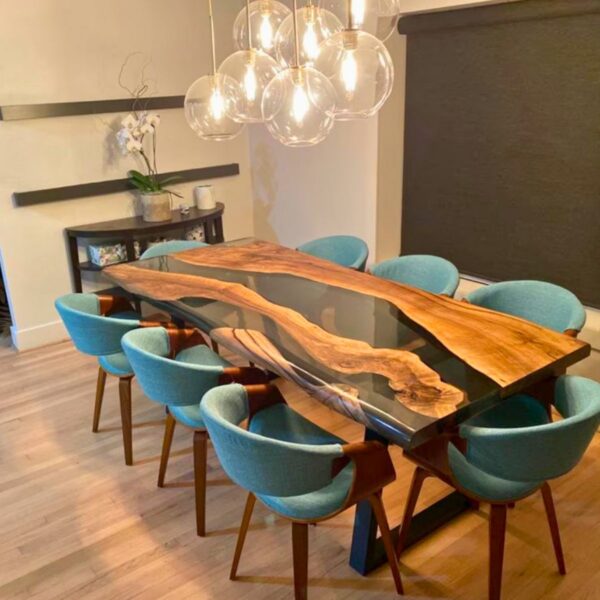 Sala de jantar com uma mesa rio de resina epóxi e oito cadeiras azuis